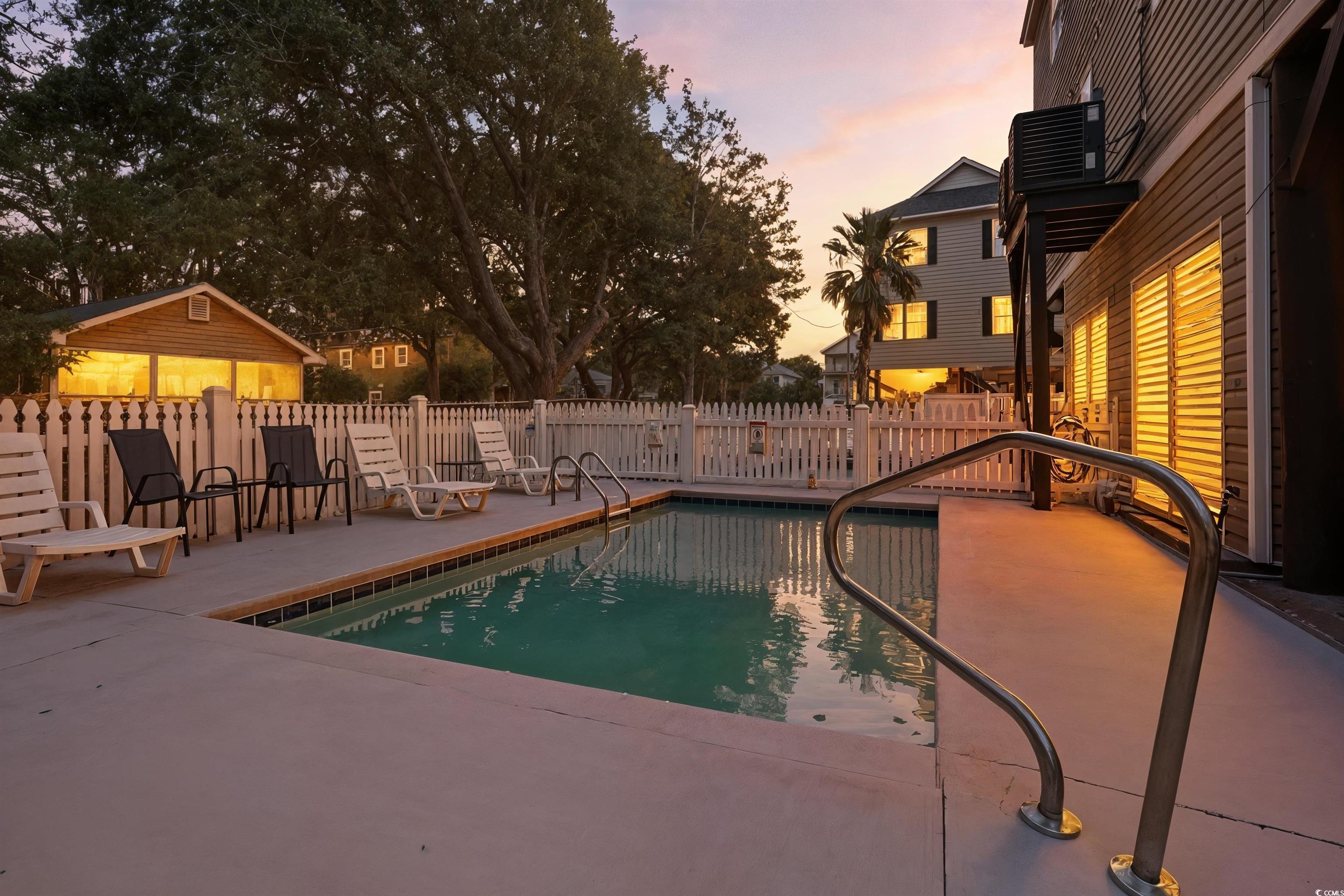 105 B Woodland Drive Murrells Inlet, SC 29576 - Photo 18 of 21 Pool at dusk featuring a patio area