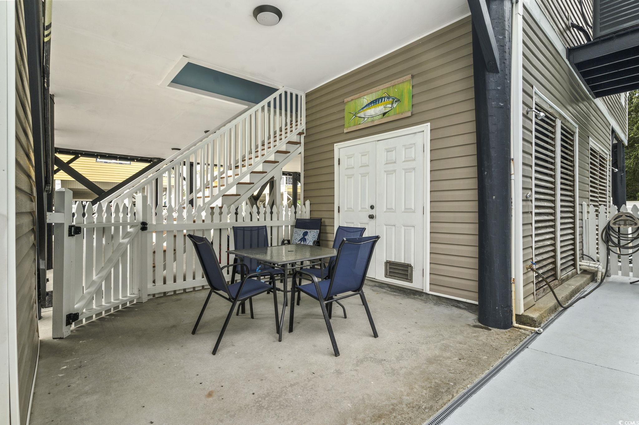 105 B Woodland Drive Murrells Inlet, SC 29576 - Photo 19 of 21 Dining room with concrete flooring and wood walls