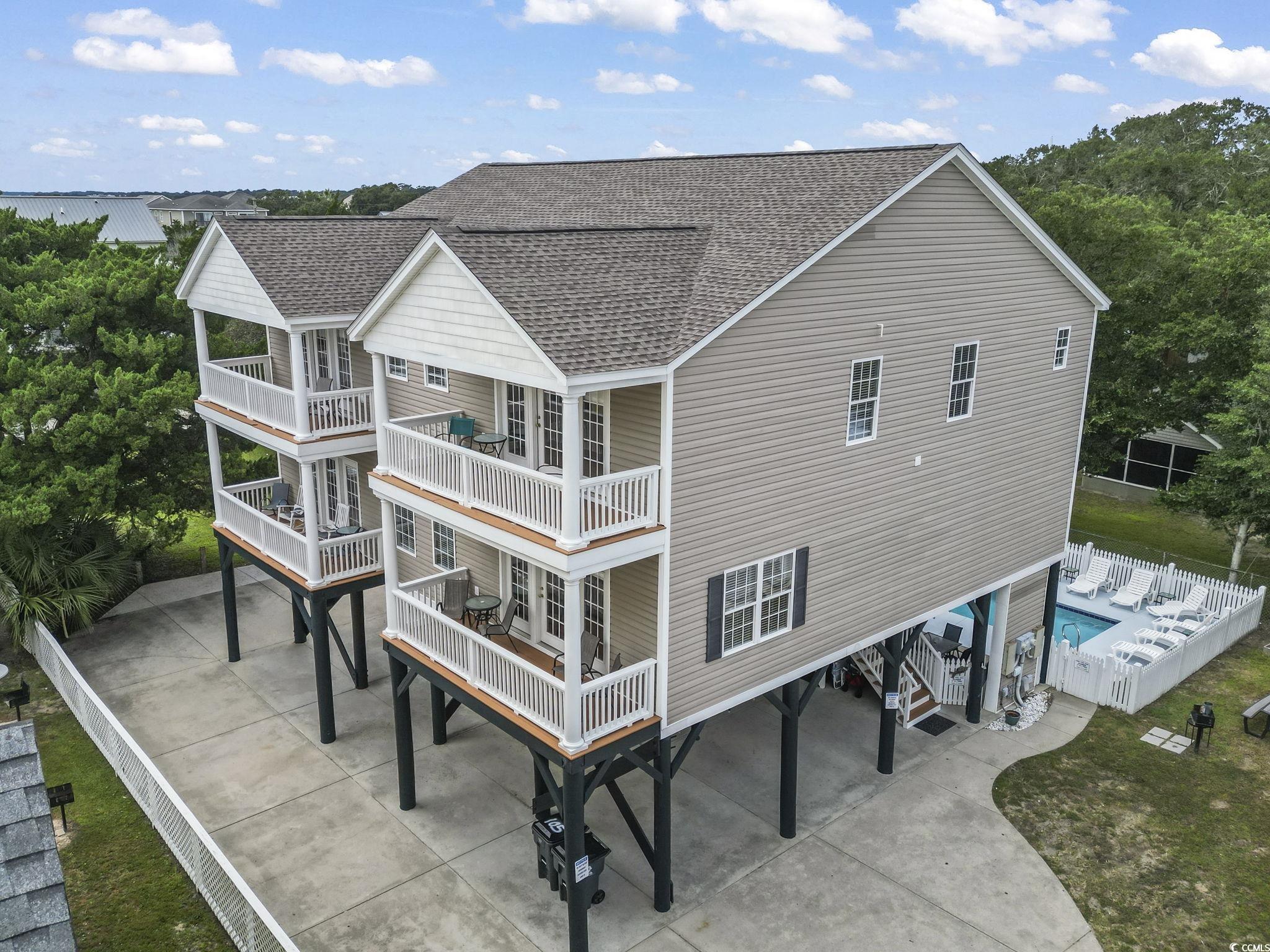 105 B Woodland Drive Murrells Inlet, SC 29576 - Photo 21 of 21 Rear view of house with a shingled roof and a patio