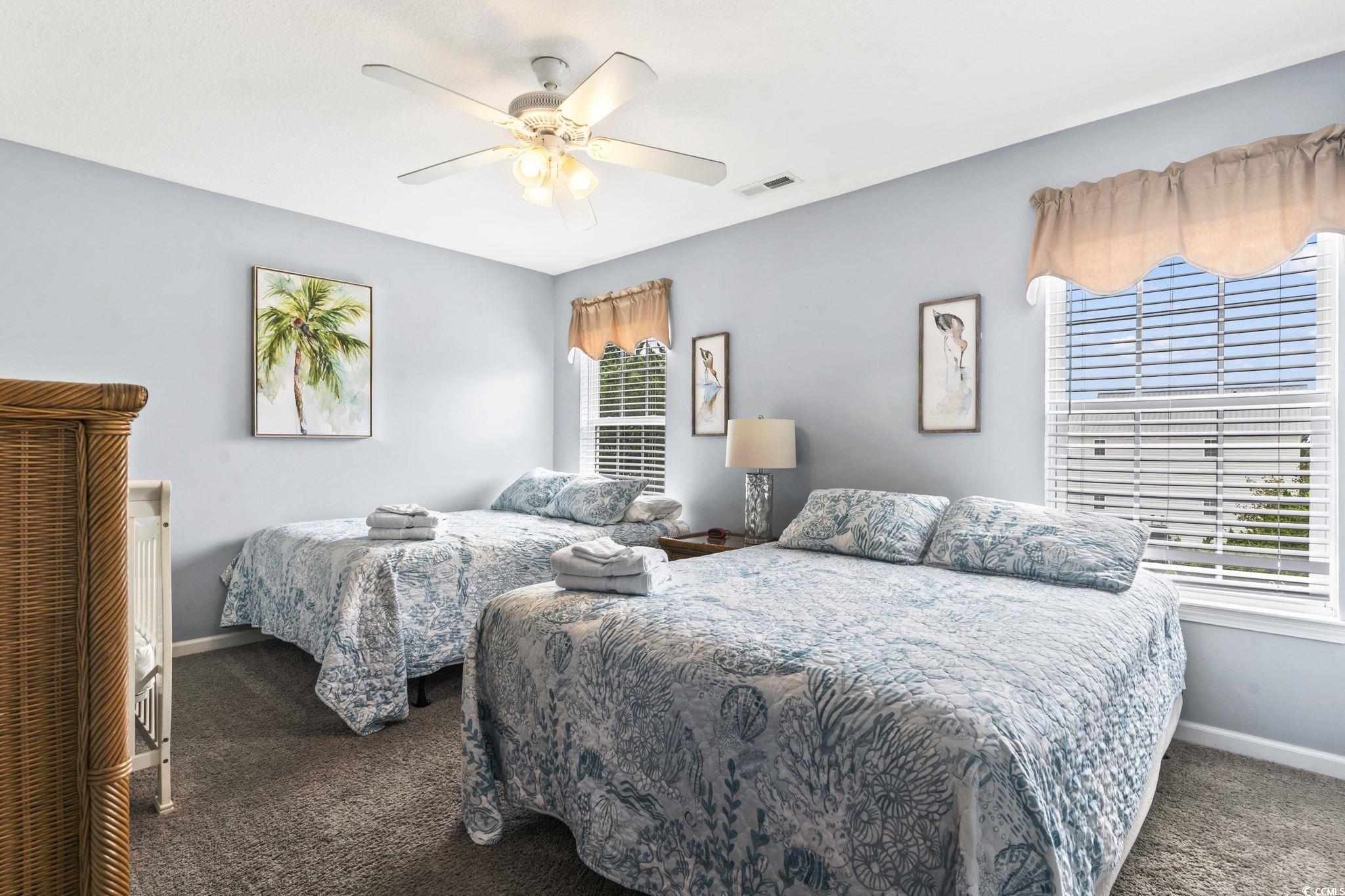 105 B Woodland Drive Murrells Inlet, SC 29576 - Photo 7 of 21 Bedroom with dark colored carpet, ceiling fan, and multiple windows