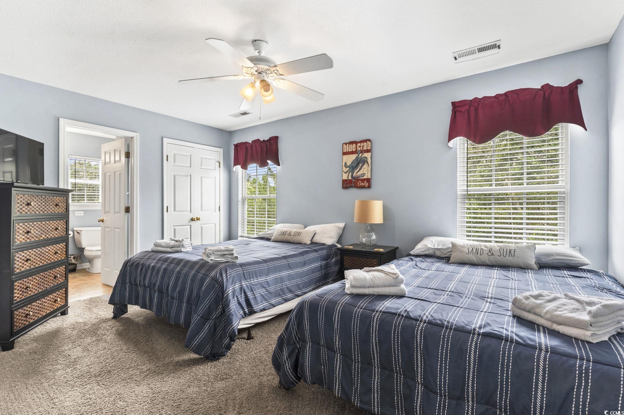 105 B Woodland Drive Murrells Inlet, SC 29576 - Photo 9 of 21 Carpeted bedroom featuring a ceiling fan and connected bathroom