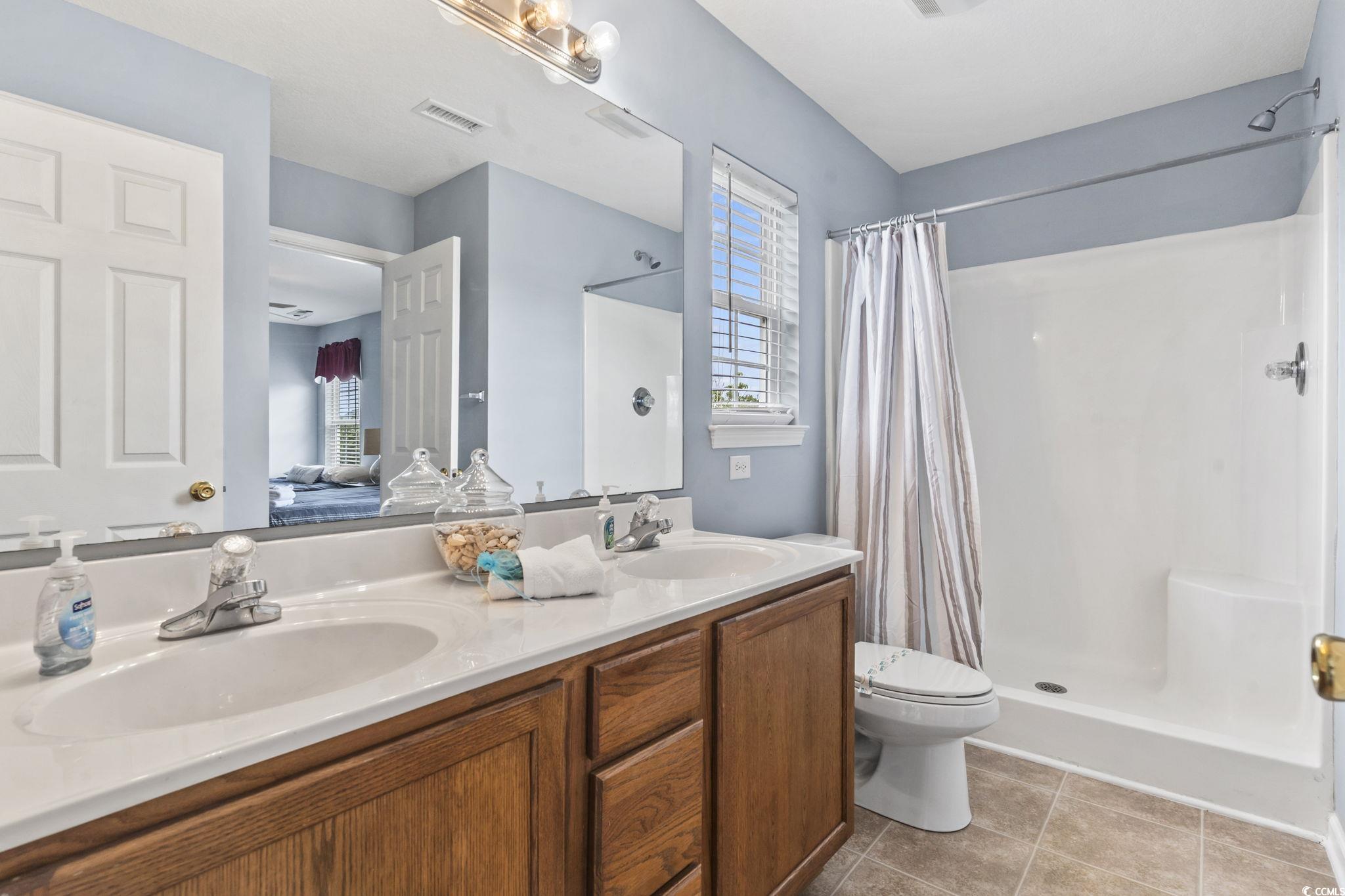 105 B Woodland Drive Murrells Inlet, SC 29576 - Photo 10 of 21 Full bath with plenty of natural light, ensuite bath, and a stall shower