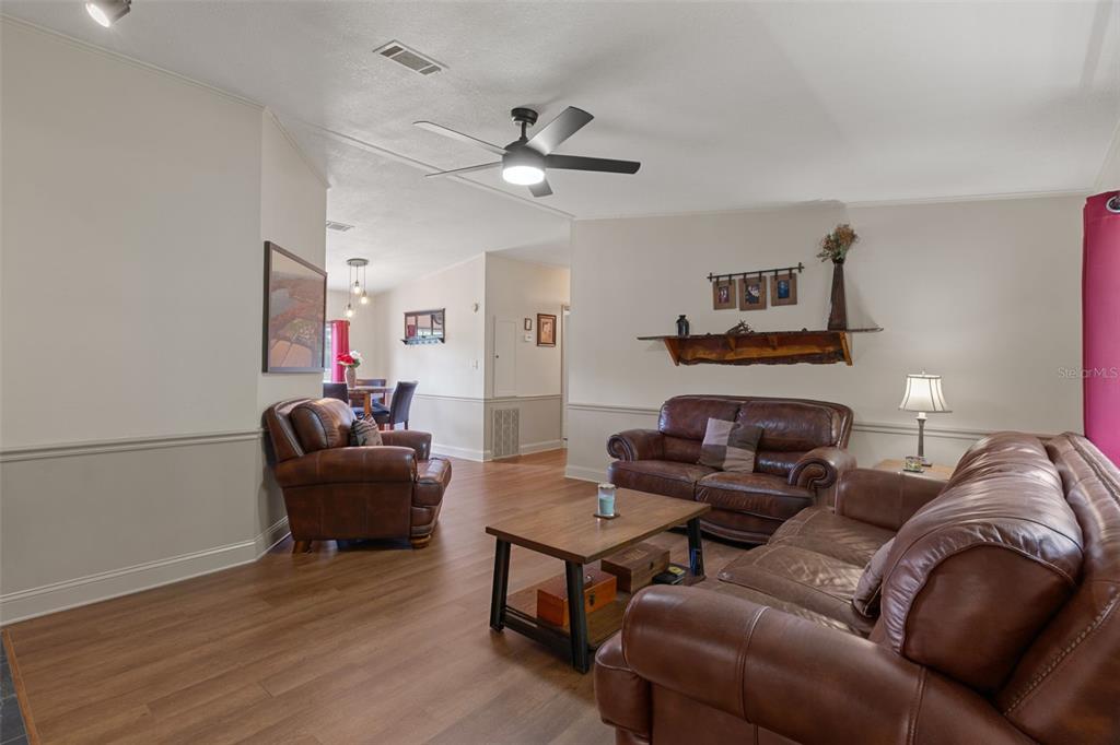 26255 Lambeth Road Brooksville, FL 34601 - Photo 27 of 76 a living room with furniture and a fireplace
