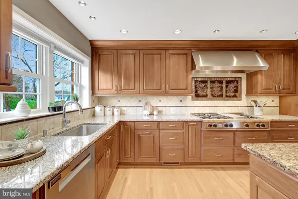 a kitchen with stainless steel appliances granite countertop a sink and cabinets