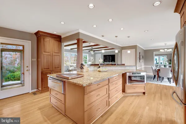 a kitchen with stainless steel appliances granite countertop a stove and a refrigerator