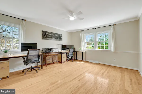 a bedroom with a bed couch chair and a window