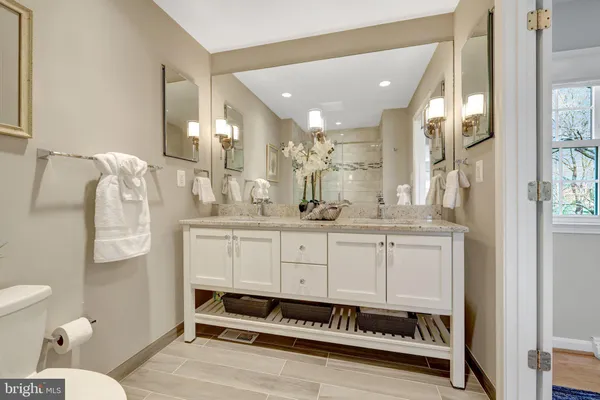 a spacious bedroom with a bed and a dresser