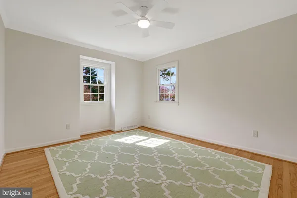 a view of a balcony with wooden floor and bench