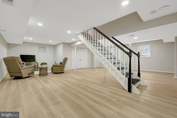 a balcony with chairs and wooden floor