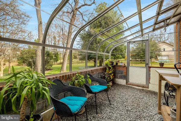 a view of patio with a table and chairs under an umbrella