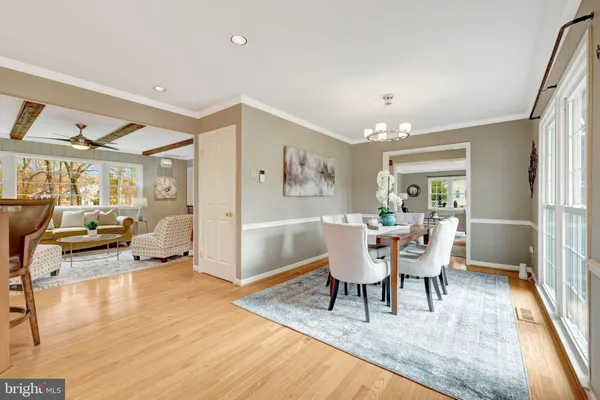 a dining room with furniture and a floor to ceiling window