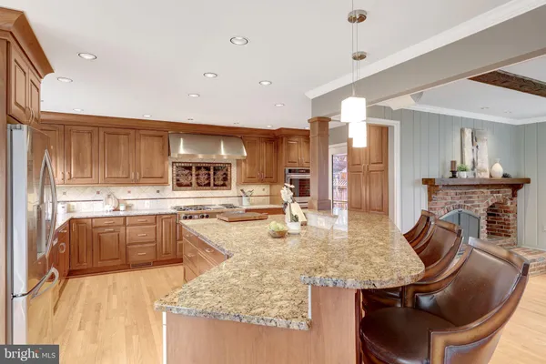 a large kitchen with granite countertop a sink and a stove