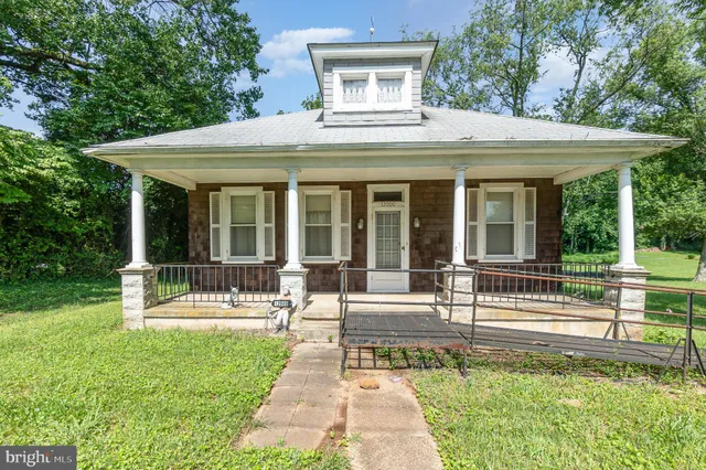 a view of a house with a yard patio and a garden