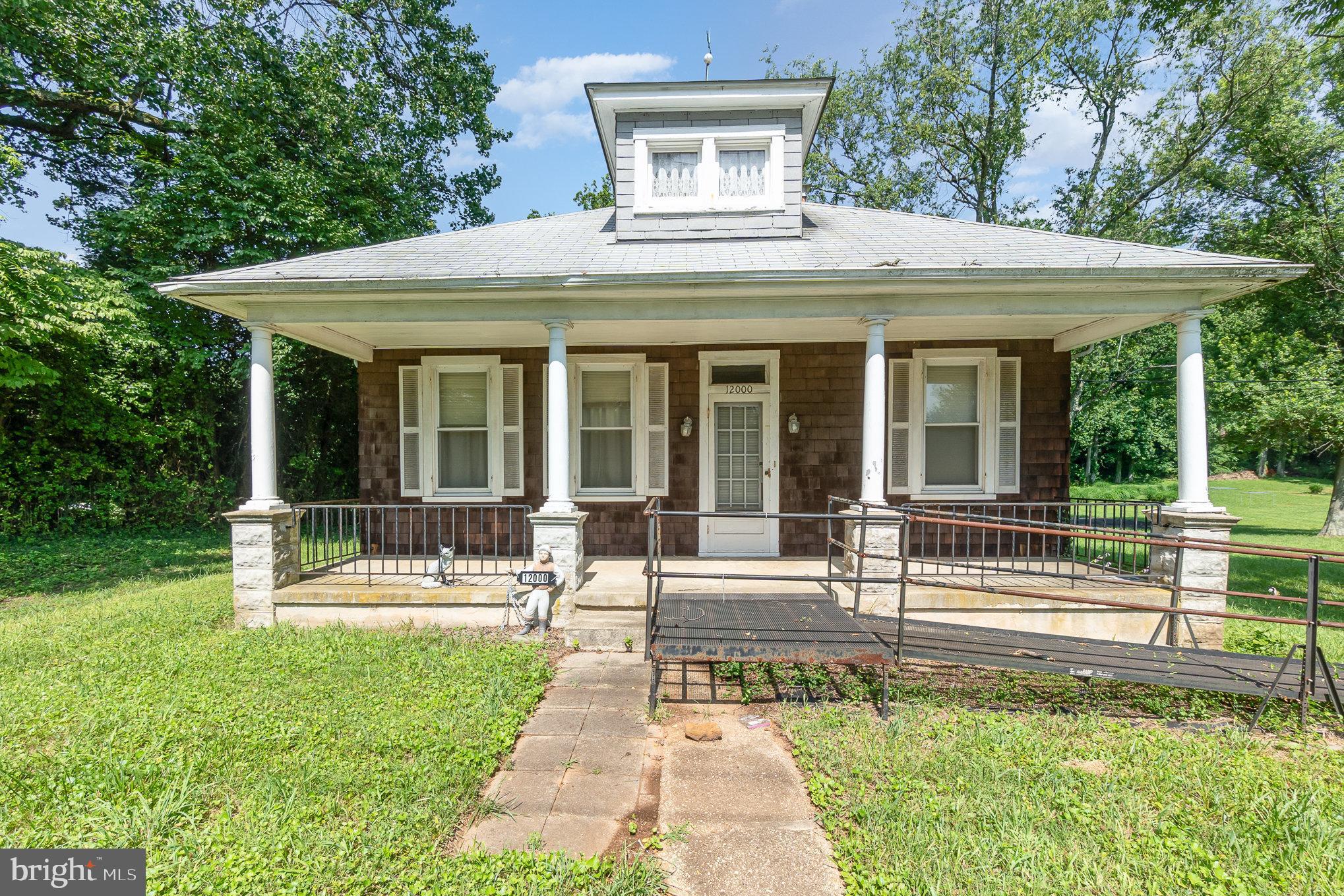 a view of a house with a yard patio and a garden