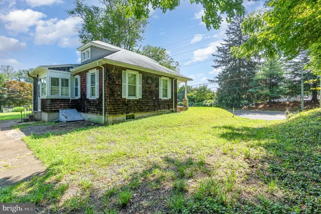 a view of a house with a yard and sitting area