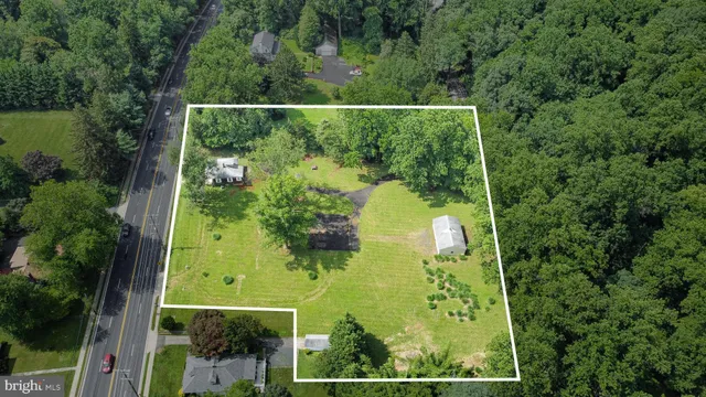 an aerial view of a residential houses with yard