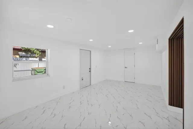 an aerial view of lake and residential houses with outdoor space