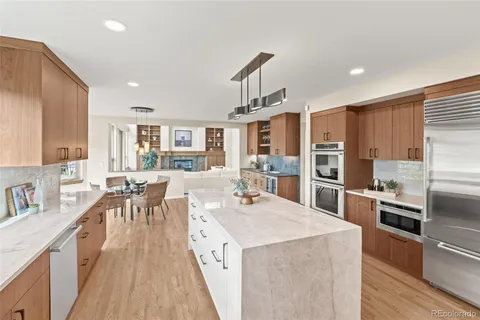 a kitchen with granite countertop a sink stainless steel appliances and cabinets