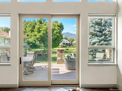 a living room with furniture large window and glass door