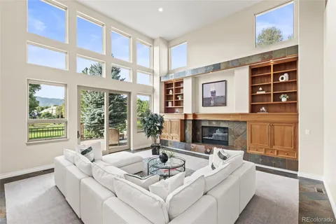a living room with stainless steel appliances kitchen island granite countertop furniture and a view of kitchen