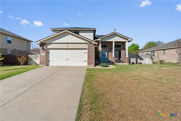 a view of garage and wooden fence