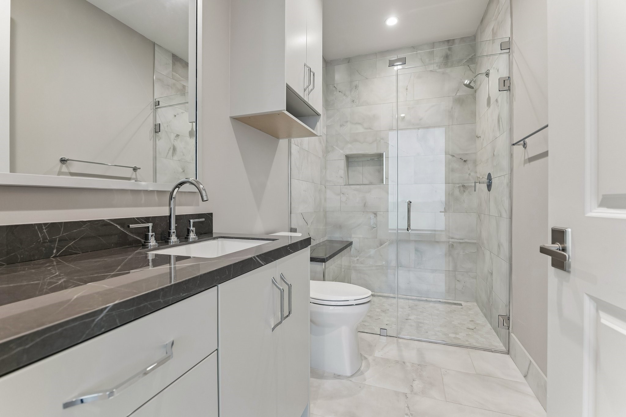5656 San Felipe Street, Unit 701 Houston, TX 77056 - Photo 20 of 44 Luxury en-suite guest bath with custom built-ins, glass enclosed walk in shower and elegant quartz counter-top