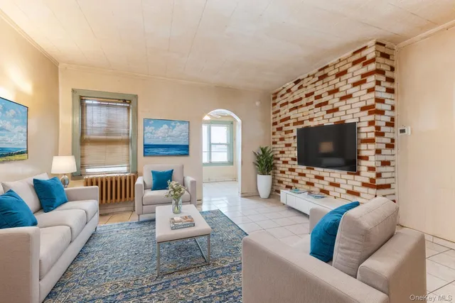 a living room with furniture a flat screen tv and a fireplace