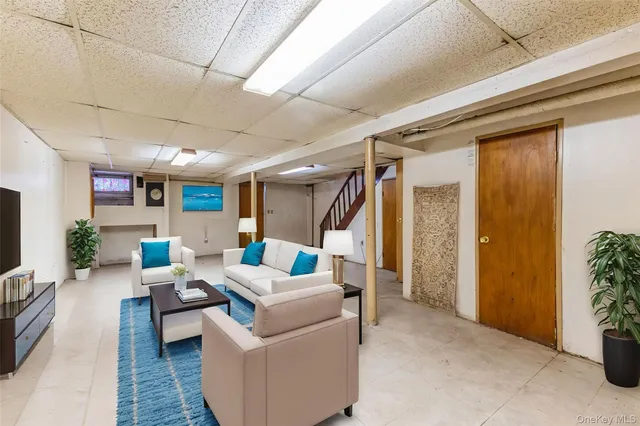 a living room with furniture and a potted plant