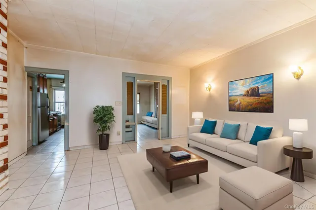 a living room with furniture and a potted plant