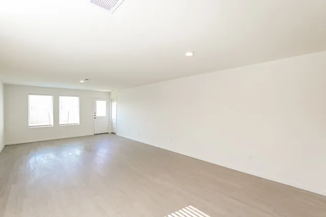 an empty room with windows and entrance