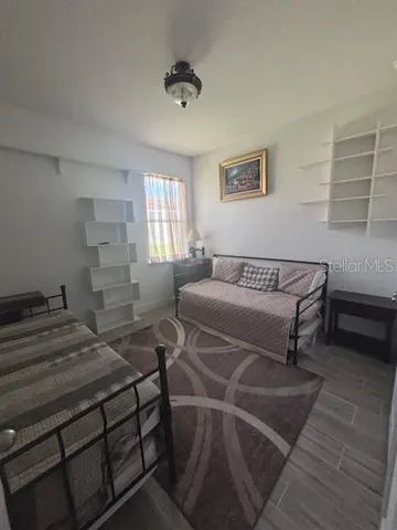 a bedroom with a bed and a night stand