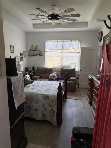 a bedroom with a bed a couch and dresser