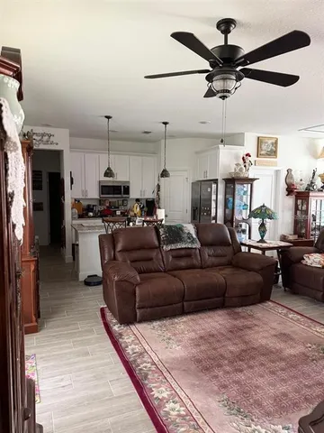 a view of a living room kitchen and a microwave