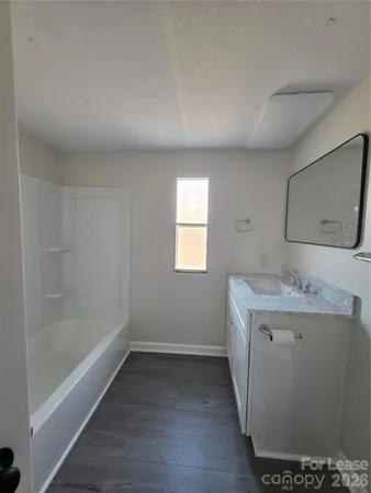 a bathroom with a sink a mirror and a bathtub