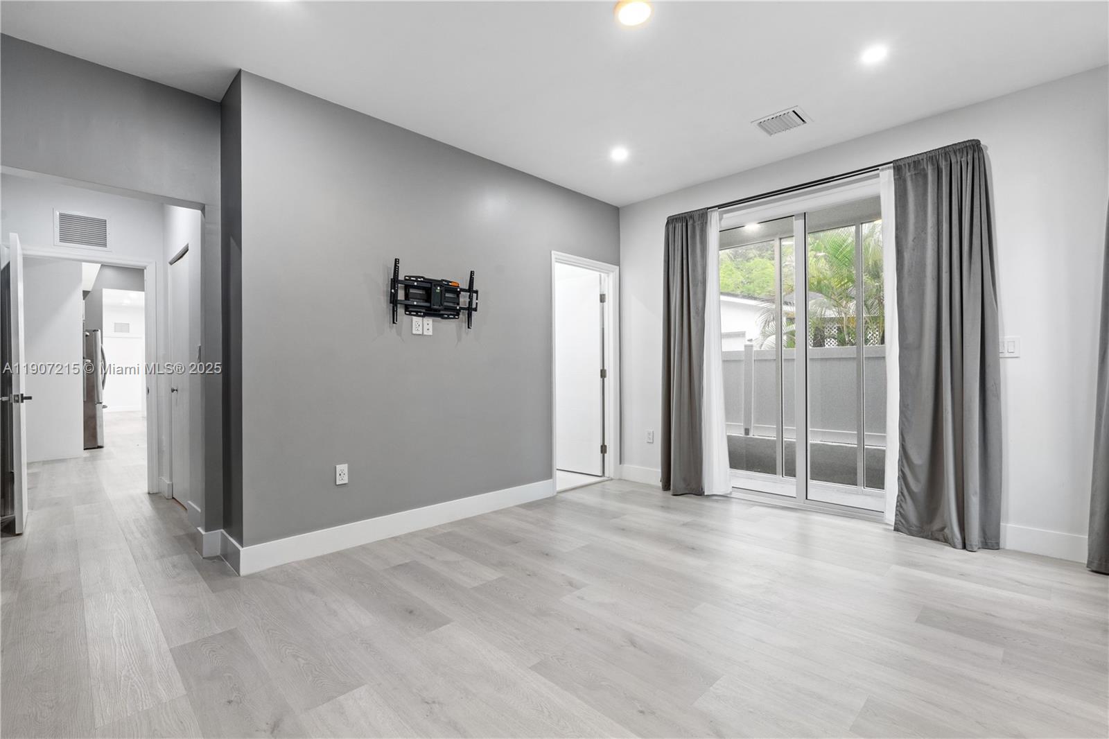5734 Buchanan Street, Unit B Hollywood, FL 33021 - Photo 11 of 21 wooden floor and windows in an empty room