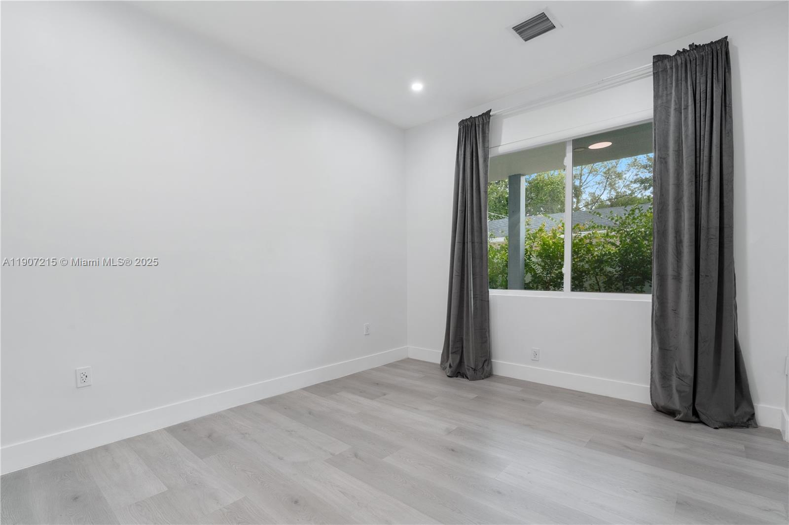 5734 Buchanan Street, Unit B Hollywood, FL 33021 - Photo 16 of 21 a view of an empty room with wooden floor and a window