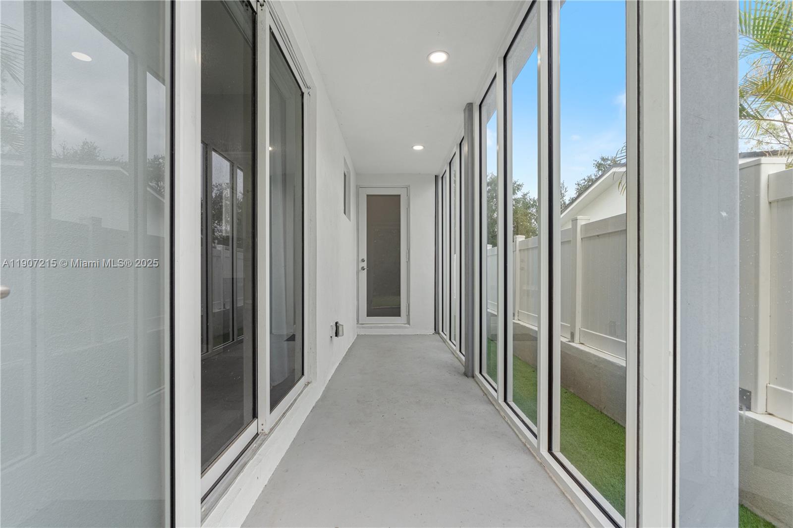 5734 Buchanan Street, Unit B Hollywood, FL 33021 - Photo 3 of 21 a view of a hallway with wooden floor and glass door