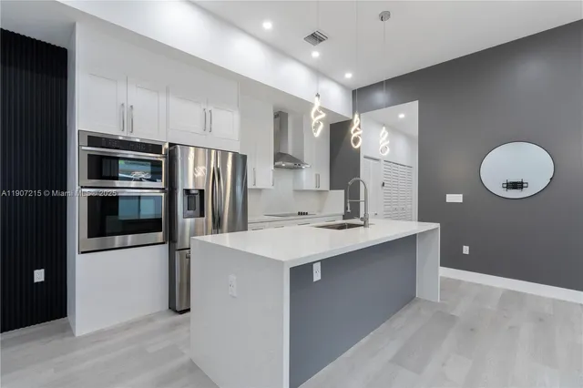 a kitchen with a sink stainless steel appliances and cabinets