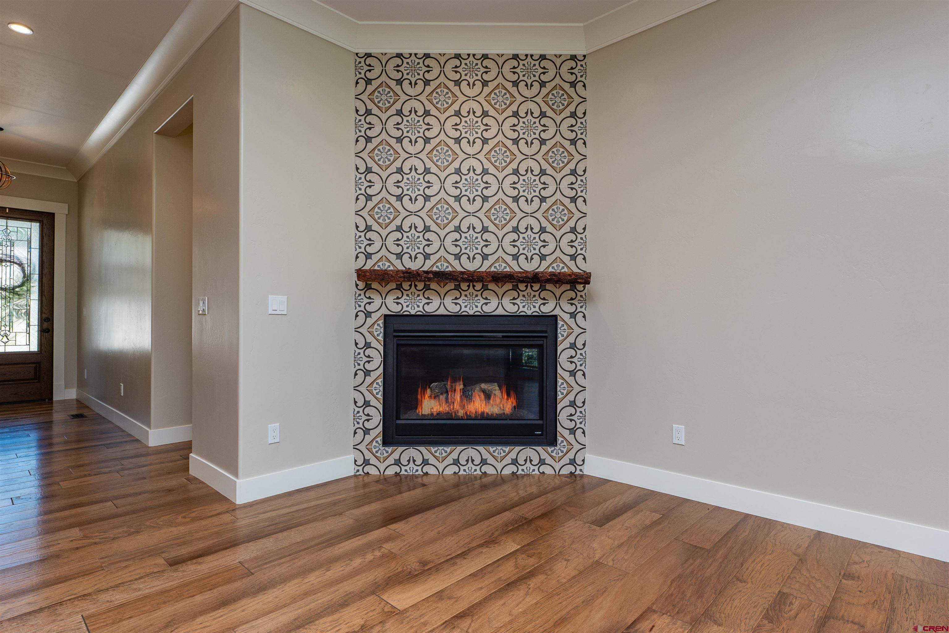 324 Hay Barn Road Durango, CO 81301 - Photo 12 of 35 a view of an empty room with wooden floor fireplace and a window