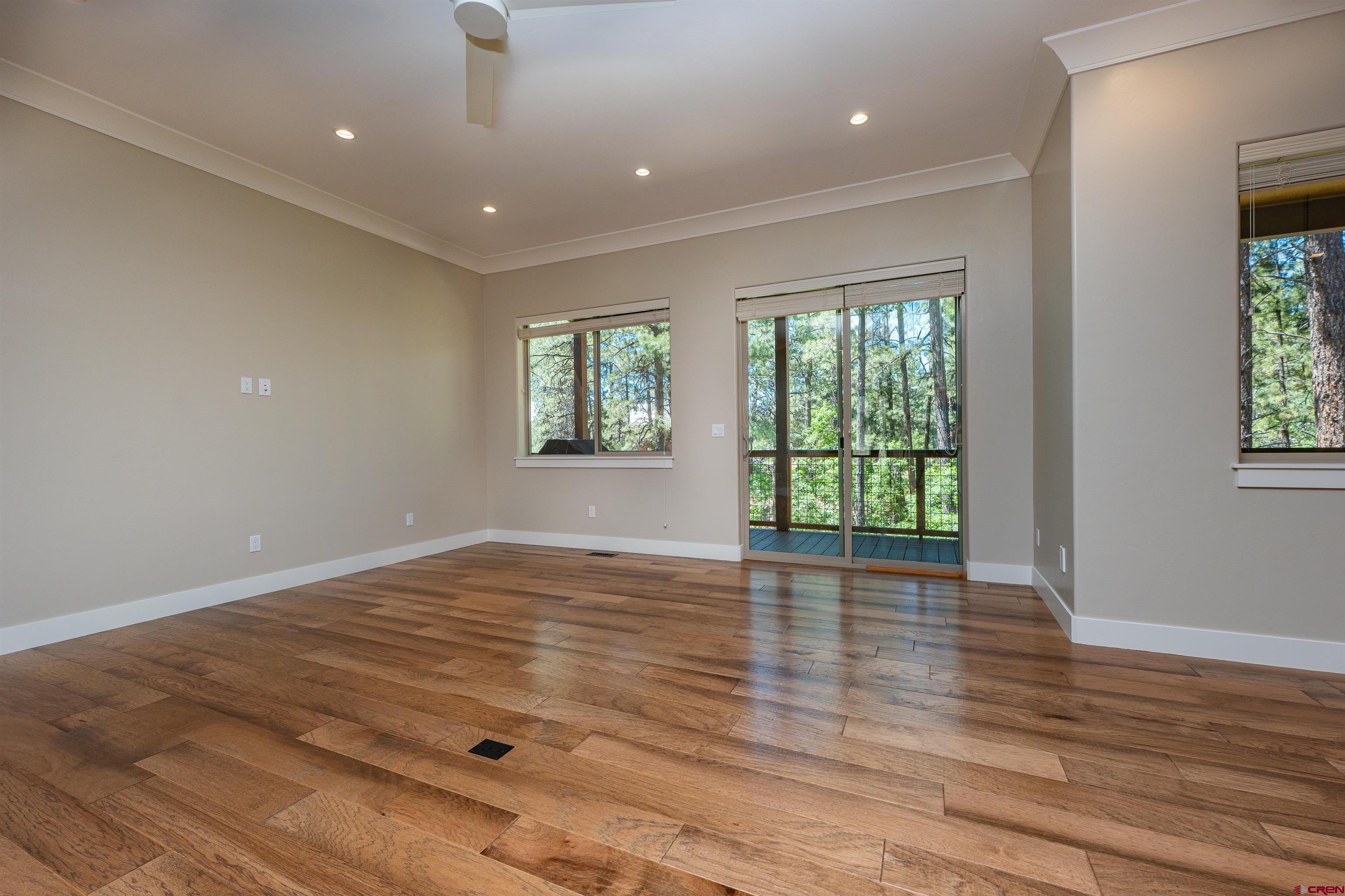 324 Hay Barn Road Durango, CO 81301 - Photo 13 of 35 a view of an empty room with wooden floor and a window