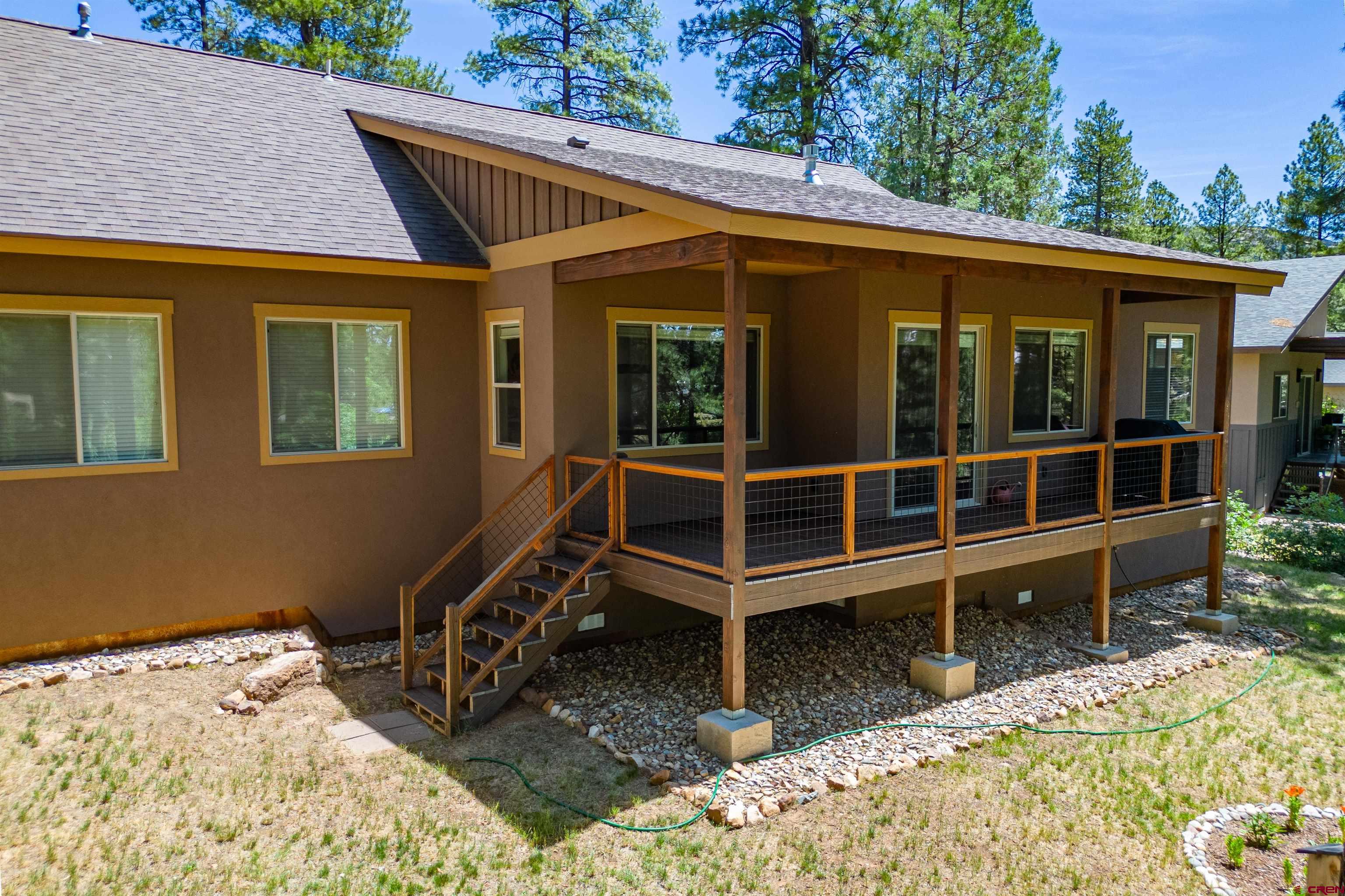 324 Hay Barn Road Durango, CO 81301 - Photo 16 of 35 a view of a house with a large window and wooden fence