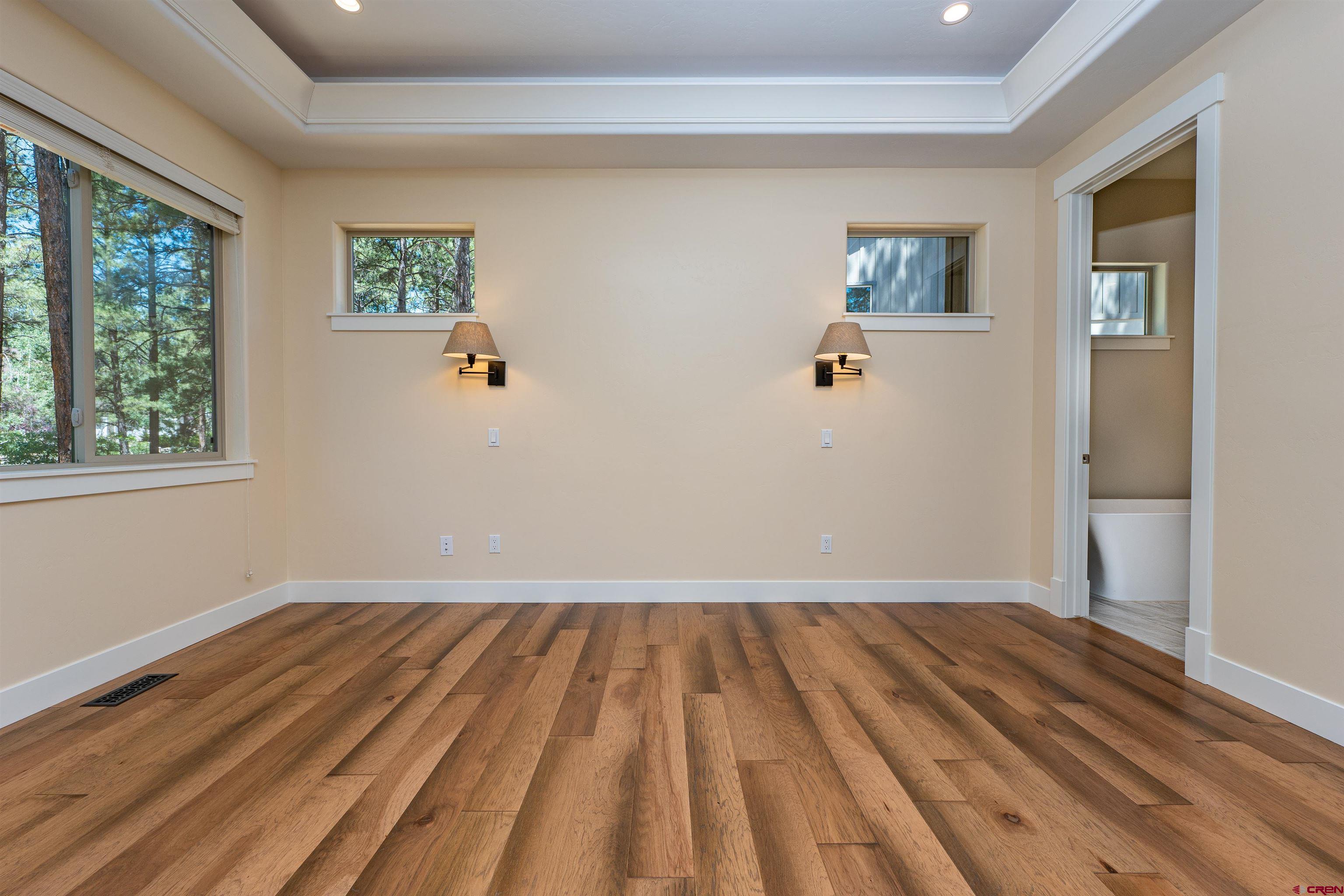 324 Hay Barn Road Durango, CO 81301 - Photo 18 of 35 a view of a room with wooden floor and windows