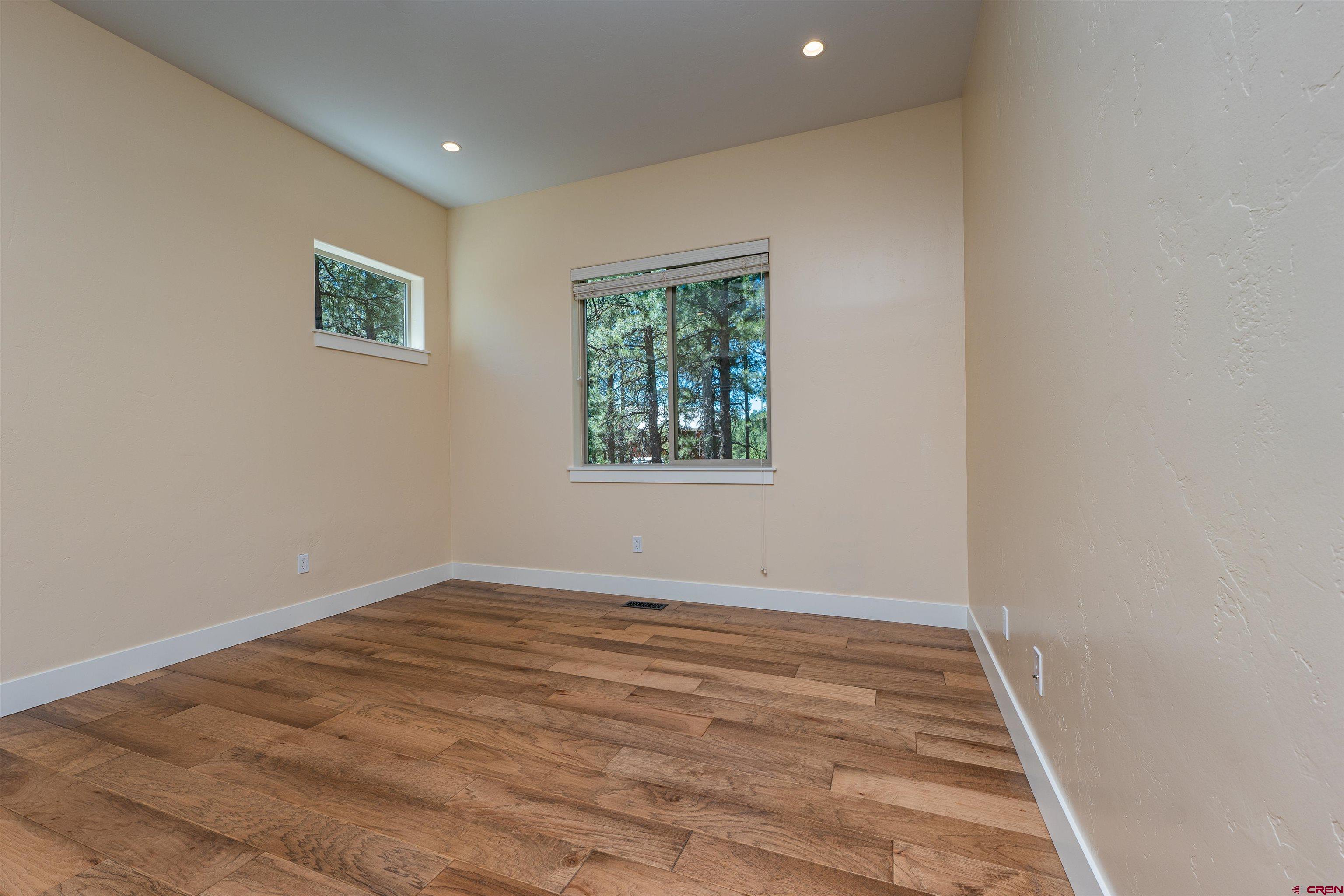 324 Hay Barn Road Durango, CO 81301 - Photo 24 of 35 an empty room with wooden floor and windows