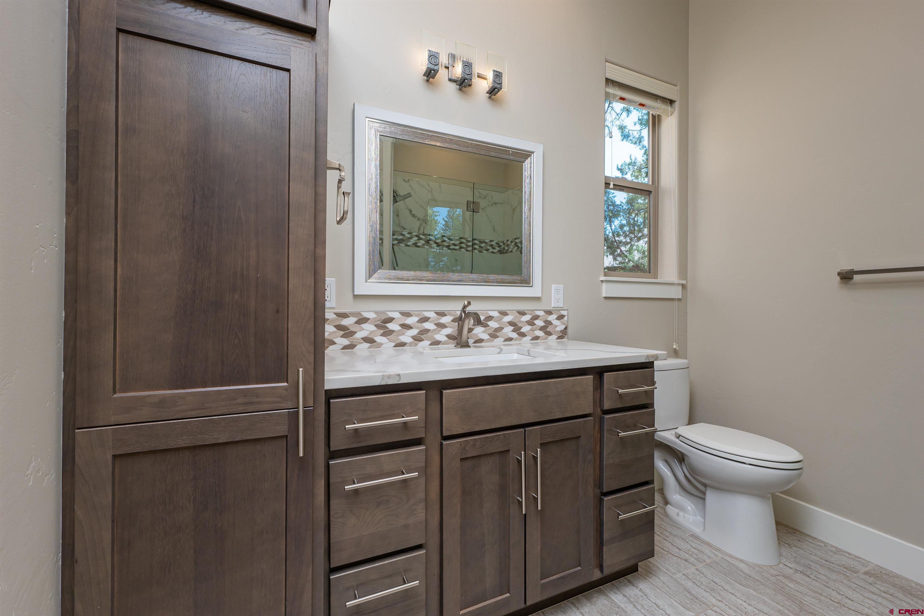 324 Hay Barn Road Durango, CO 81301 - Photo 26 of 35 a bathroom with a toilet sink and mirror