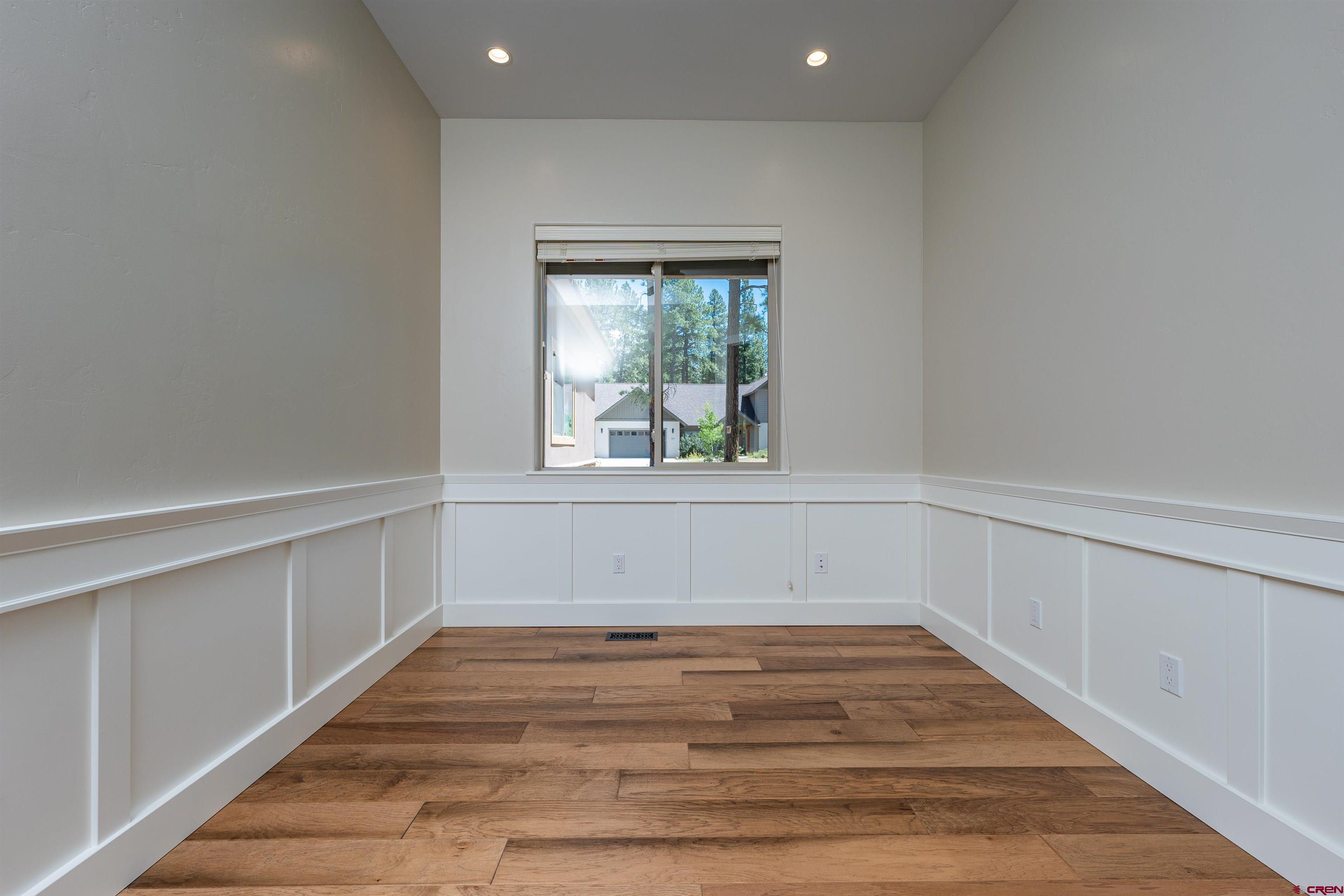 324 Hay Barn Road Durango, CO 81301 - Photo 29 of 35 a view of an empty room with wooden floor and a window