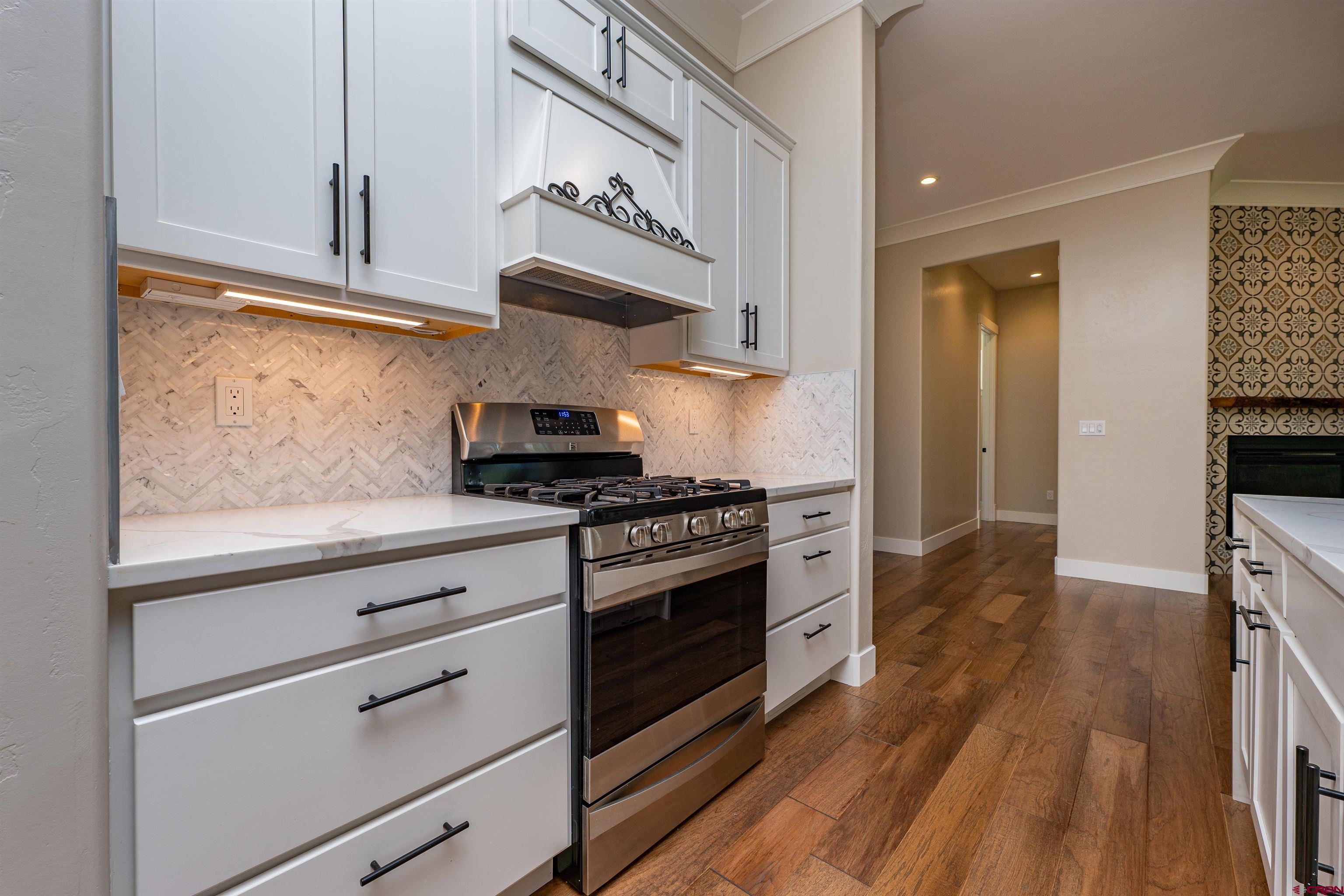 324 Hay Barn Road Durango, CO 81301 - Photo 7 of 35 a kitchen with stainless steel appliances granite countertop a stove and a refrigerator