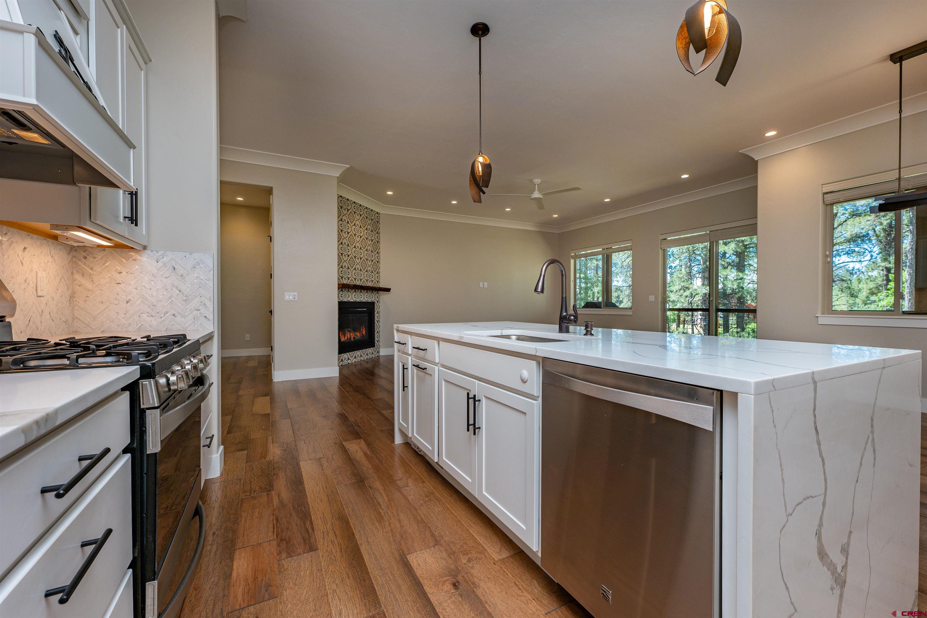 324 Hay Barn Road Durango, CO 81301 - Photo 8 of 35 a kitchen with stainless steel appliances granite countertop a stove and a sink