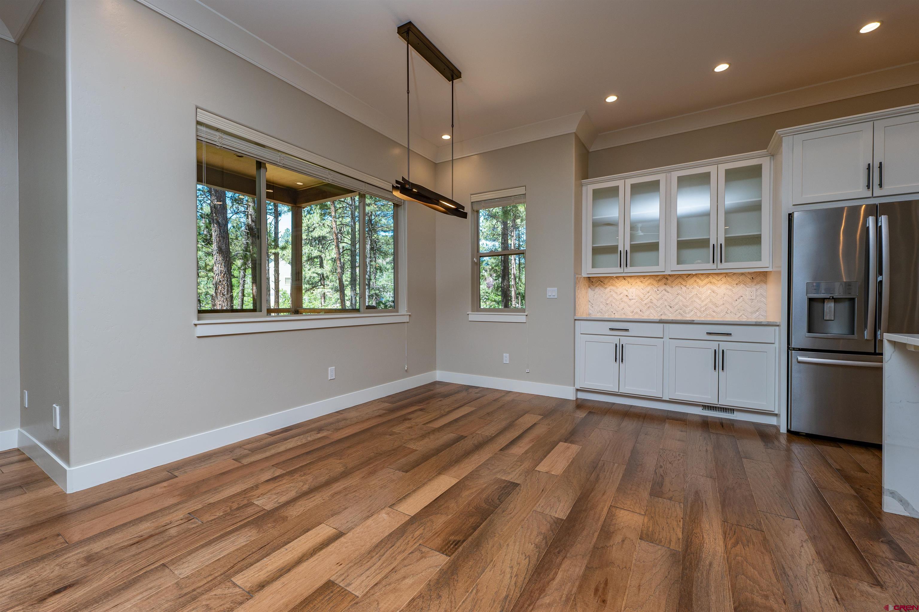 324 Hay Barn Road Durango, CO 81301 - Photo 9 of 35 a view of an empty room with a window and wooden floor