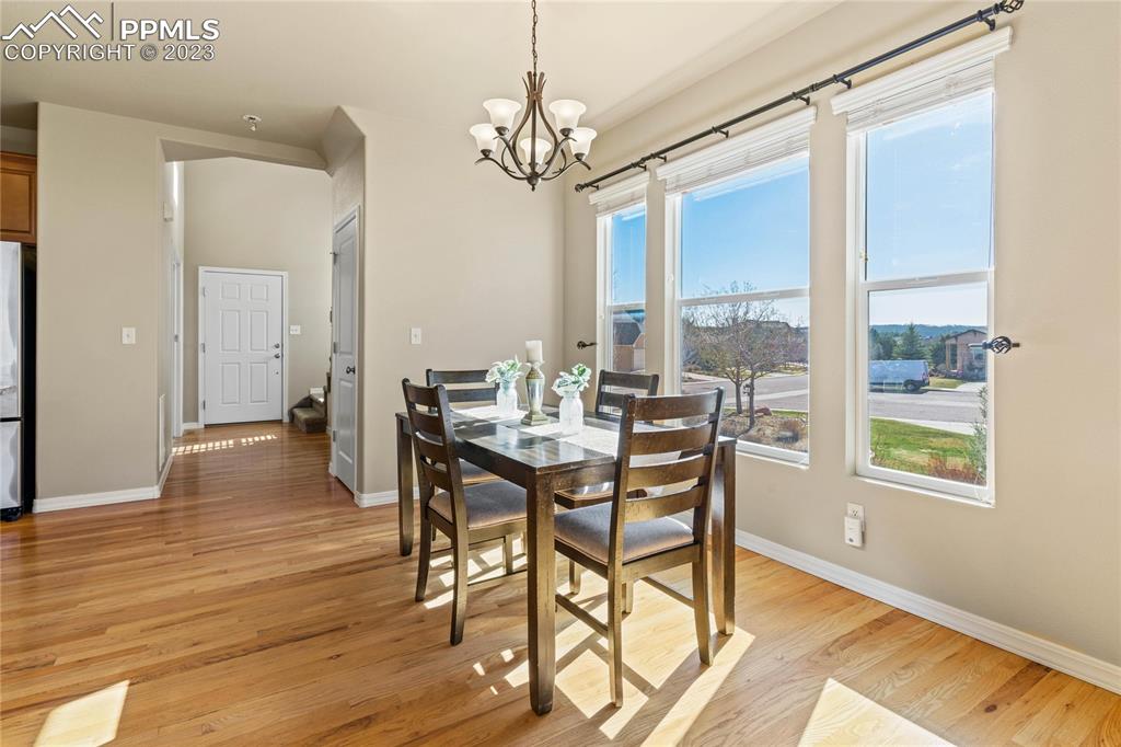 2423 Cinnabar Road Colorado Springs, CO 80921 - Photo 14 of 40 a view of a dining room with furniture window and wooden floor