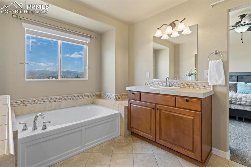2423 Cinnabar Road Colorado Springs, CO 80921 - Photo 21 of 40 a bathroom with a tub sink and mirror